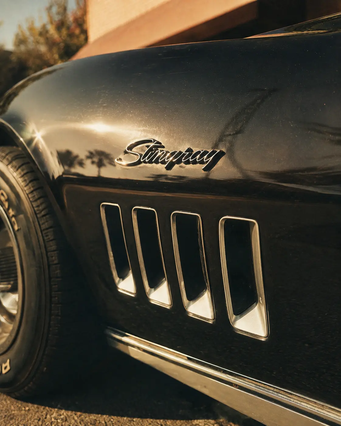 Close-up of a black Corvette Stingray badge and side vents